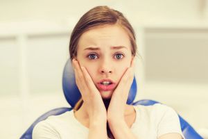 Anxious young woman at orthodontic appointment