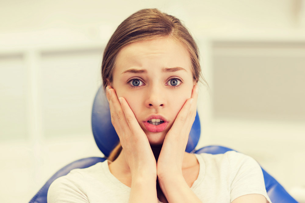 Anxious young woman at orthodontic appointment